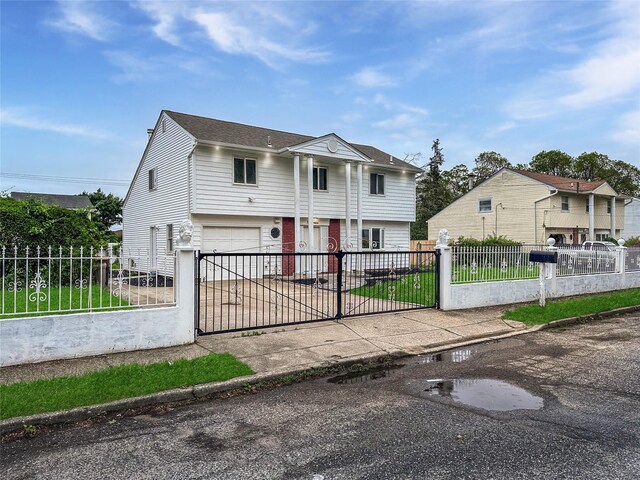 19 Leaf Ave, Central Islip, NY 11722 - view of front of home featuring a garage, driveway, and a fenced front yard
