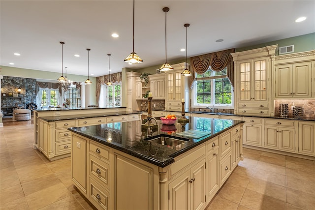 5 Westgate Rd, Muttontown, NY 11791 - kitchen featuring cream cabinets, decorative backsplash, a sink, and recessed lighting