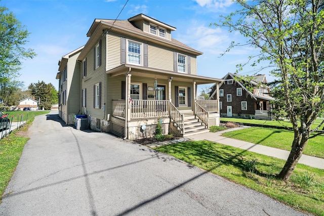 203 Highland Ave, Middletown, NY 10940 - american foursquare style home with a porch, a front lawn, and cooling unit