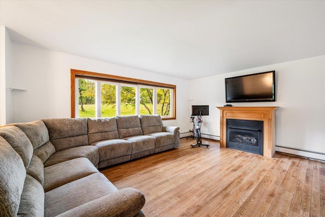 184 Mt Prosper Rd, Wurtsboro, NY 12790 - living room featuring wood finished floors, a glass covered fireplace, and a baseboard radiator