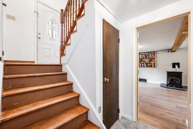 184 Mt Prosper Rd, Wurtsboro, NY 12790 - stairway featuring a wood stove, wood finished floors, and baseboards