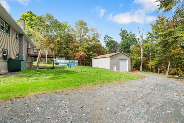 184 Mt Prosper Rd, Wurtsboro, NY 12790 - view of green lawn featuring stairway, a garage, a wooden deck, an outbuilding, and dirt driveway