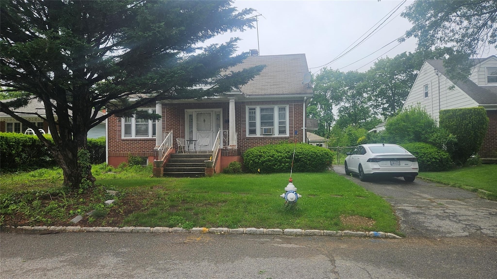 37 Netz Pl, Albertson, NY 11507 - bungalow with brick siding, a front lawn, and asphalt driveway
