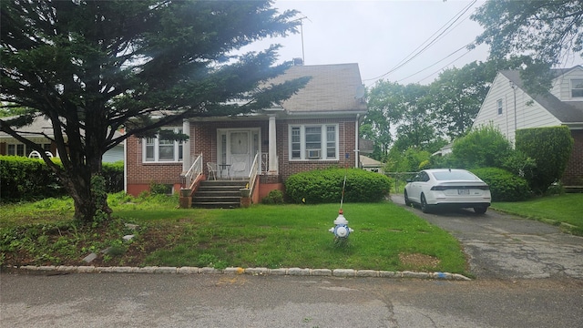 37 Netz Pl, Albertson, NY 11507 - bungalow with brick siding, a front lawn, and asphalt driveway