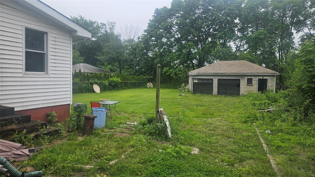 37 Netz Pl, Albertson, NY 11507 - view of green lawn with an outbuilding and a detached garage
