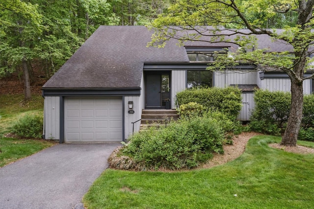 348 Heritage Hls Unit A, Somers, NY 10589 - view of front of home with a shingled roof, an attached garage, and driveway