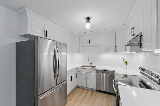 348 Heritage Hls Unit A, Somers, NY 10589 - kitchen with stainless steel appliances, a sink, under cabinet range hood, and white cabinetry