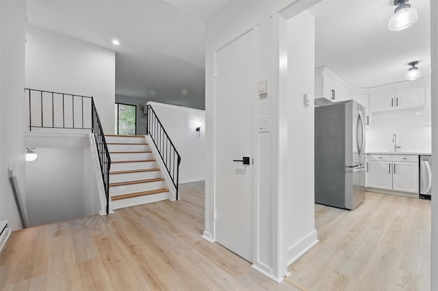 348 Heritage Hls Unit A, Somers, NY 10589 - corridor featuring a sink, light wood-style flooring, stairway, and recessed lighting