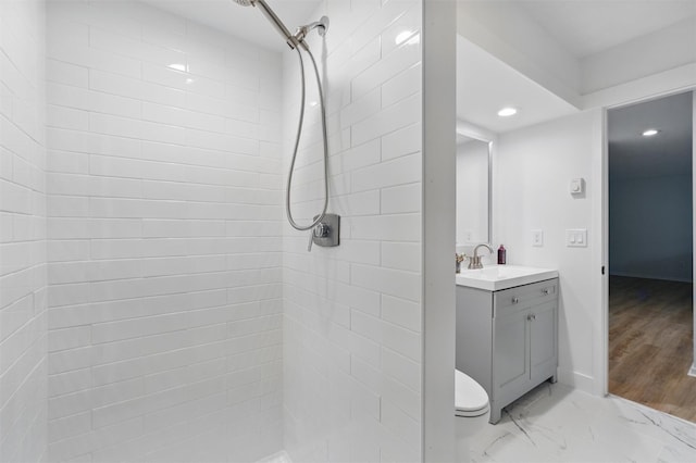 348 Heritage Hls Unit A, Somers, NY 10589 - bathroom featuring a tile shower, vanity, recessed lighting, toilet, and baseboards
