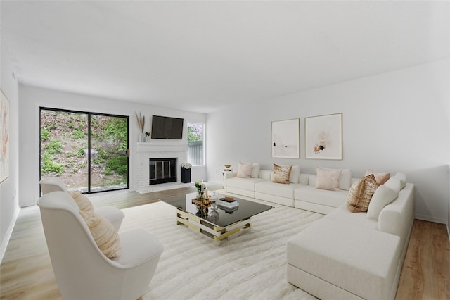 348 Heritage Hls Unit A, Somers, NY 10589 - living area featuring light wood finished floors, a fireplace, and baseboards