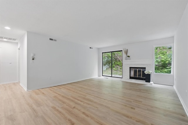 348 Heritage Hls Unit A, Somers, NY 10589 - unfurnished living room featuring light wood finished floors, a fireplace, and baseboards