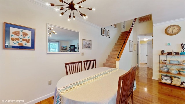 50 Snowden Ave, Ossining, NY 10562 - dining area featuring a chandelier, ornamental molding, wood finished floors, baseboards, and stairs