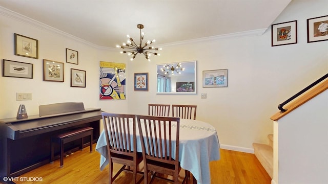 50 Snowden Ave, Ossining, NY 10562 - dining space featuring a chandelier, ornamental molding, wood finished floors, baseboards, and stairs