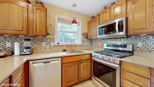 50 Snowden Ave, Ossining, NY 10562 - kitchen featuring appliances with stainless steel finishes, a sink, backsplash, and light countertops
