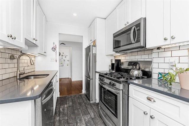 4265 Webster Ave Unit 3H, Bronx, NY 10470 - kitchen featuring stainless steel appliances, a sink, dark wood-style flooring, white cabinets, and backsplash