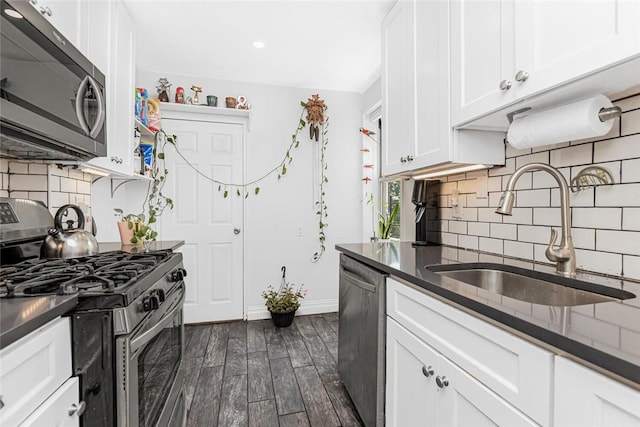4265 Webster Ave Unit 3H, Bronx, NY 10470 - kitchen featuring appliances with stainless steel finishes, a sink, tasteful backsplash, white cabinets, and dark wood finished floors