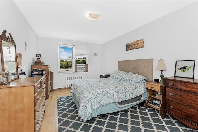 4265 Webster Ave Unit 3H, Bronx, NY 10470 - bedroom with radiator, light wood finished floors, and cooling unit