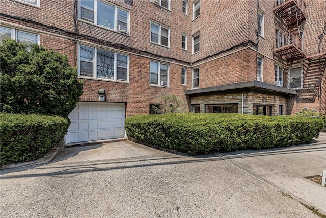 4265 Webster Ave Unit 3H, Bronx, NY 10470 - view of building exterior with an attached garage and driveway