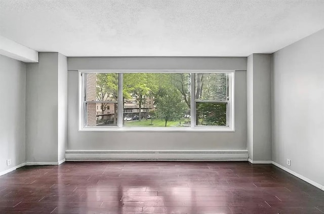 3 Fordham Hill Oval Unit 3D, Bronx, NY 10468 - empty room featuring plenty of natural light, wood finished floors, a baseboard radiator, a textured ceiling, and baseboards