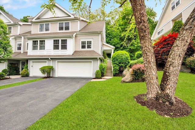 145 Underhill Ln Unit 145, Peekskill, NY 10566 - view of front of house with a garage, driveway, a front yard, roof with shingles, and stairway