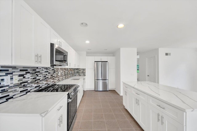 145 Underhill Ln Unit 145, Peekskill, NY 10566 - kitchen with appliances with stainless steel finishes, a sink, backsplash, white cabinets, and recessed lighting