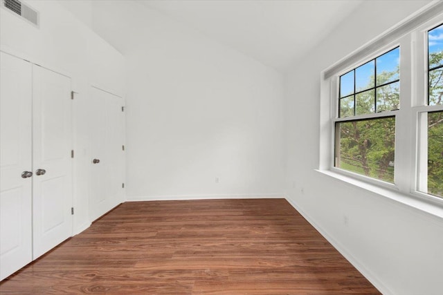 145 Underhill Ln Unit 145, Peekskill, NY 10566 - unfurnished bedroom featuring multiple windows, lofted ceiling, wood finished floors, and baseboards