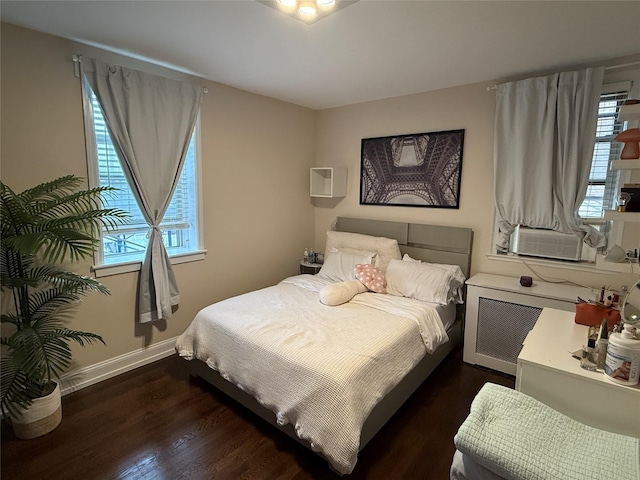 208 Centre Ave Unit 2J, New Rochelle, NY 10805 - bedroom with dark wood-style flooring, cooling unit, and baseboards