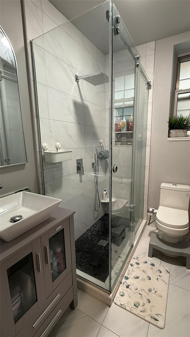208 Centre Ave Unit 2J, New Rochelle, NY 10805 - bathroom with vanity, a stall shower, toilet, and marble look tile flooring
