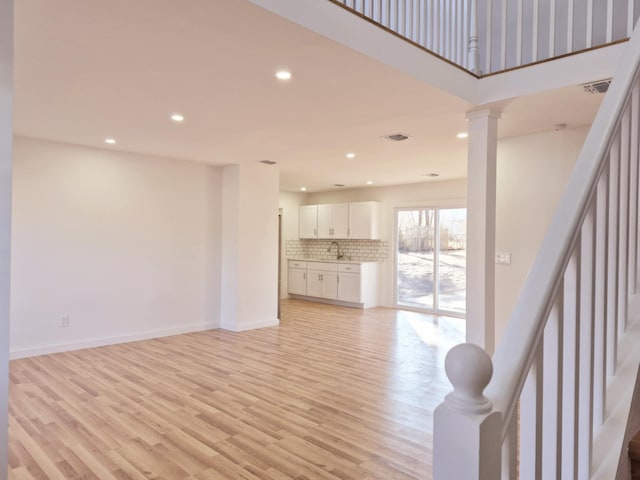 52 Nottingham Dr, Middle Island, NY 11953 - living room featuring light wood-style flooring, recessed lighting, baseboards, and decorative columns