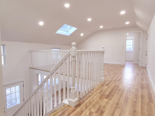 52 Nottingham Dr, Middle Island, NY 11953 - corridor featuring a skylight, an upstairs landing, vaulted ceiling, recessed lighting, and light wood finished floors
