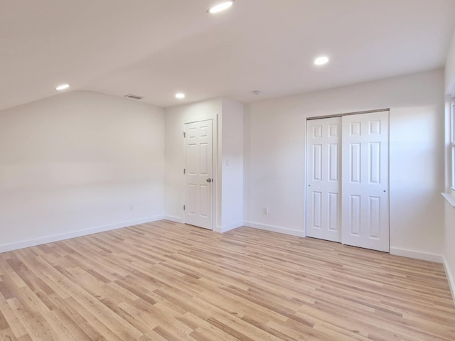 52 Nottingham Dr, Middle Island, NY 11953 - unfurnished bedroom with light wood finished floors, recessed lighting, baseboards, and vaulted ceiling