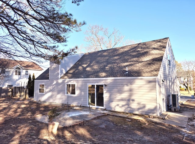 52 Nottingham Dr, Middle Island, NY 11953 - back of property with a patio, a chimney, roof with shingles, and central air condition unit