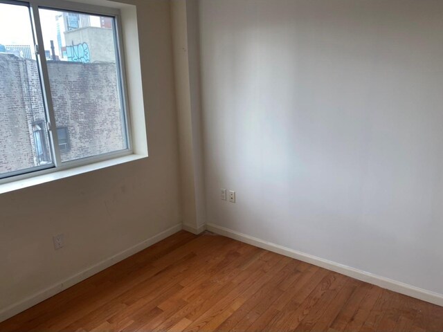 86 Canal St, New York Manhattan, NY 10002 - unfurnished room featuring light wood-style flooring and baseboards