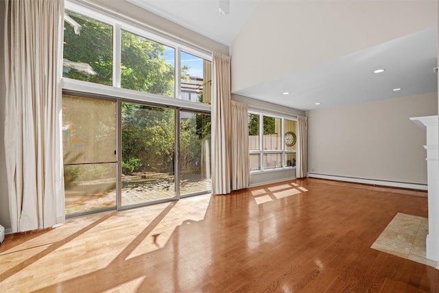6 Chippewa Ct, Suffern, NY 10901 - unfurnished living room with a baseboard radiator, wood finished floors, high vaulted ceiling, and recessed lighting
