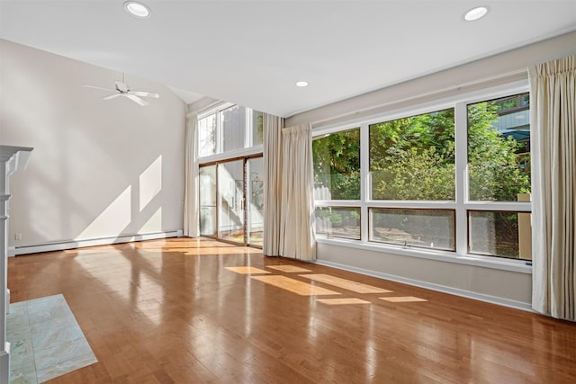 6 Chippewa Ct, Suffern, NY 10901 - unfurnished living room with wood finished floors, a baseboard radiator, a ceiling fan, recessed lighting, and baseboards