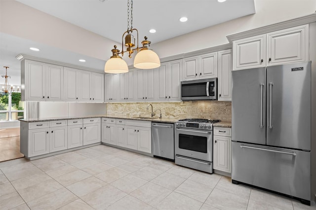 6 Chippewa Ct, Suffern, NY 10901 - kitchen with stainless steel appliances, a chandelier, a sink, backsplash, and light stone countertops