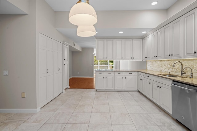 6 Chippewa Ct, Suffern, NY 10901 - kitchen featuring dishwasher, a sink, baseboards, backsplash, and light stone countertops