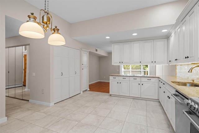 6 Chippewa Ct, Suffern, NY 10901 - kitchen with a sink, a baseboard heating unit, light stone countertops, dishwasher, and white cabinetry