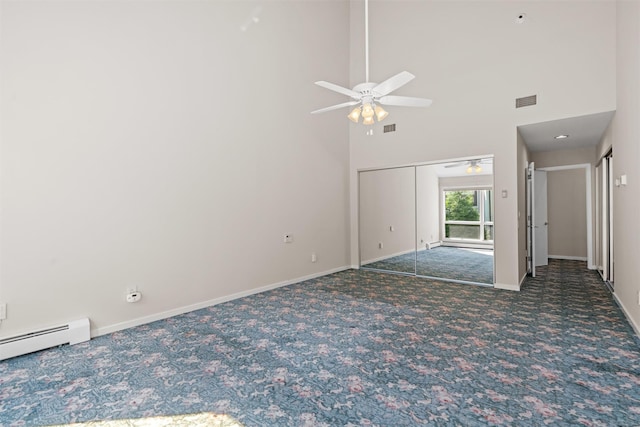 6 Chippewa Ct, Suffern, NY 10901 - spare room with carpet floors, a ceiling fan, baseboards, a baseboard radiator, and a towering ceiling