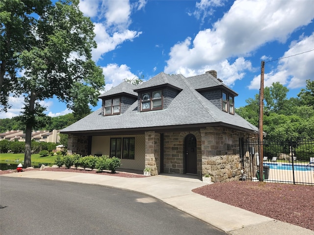 6 Chippewa Ct, Suffern, NY 10901 - view of front of house with stone siding, a shingled roof, and a chimney