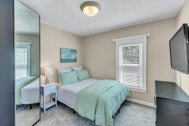 312 5th Ave, Greenport, NY 11944 - bedroom featuring light colored carpet, baseboards, and a textured ceiling