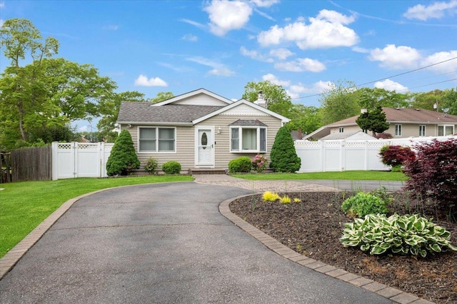 12 Midwood Pl, Farmingville, NY 11738 - bungalow featuring driveway and a shingled roof