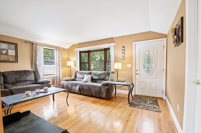 12 Midwood Pl, Farmingville, NY 11738 - living area with vaulted ceiling, light wood-style flooring, and baseboards