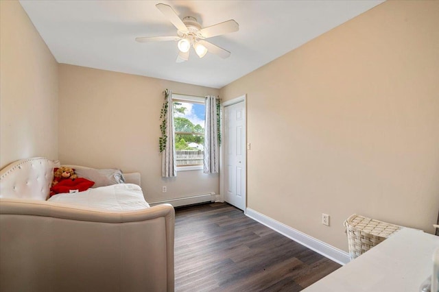 12 Midwood Pl, Farmingville, NY 11738 - bedroom with dark wood finished floors, baseboards, a baseboard heating unit, and a ceiling fan