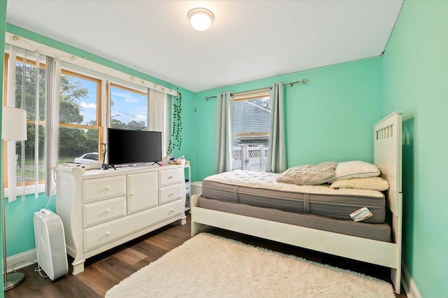 12 Midwood Pl, Farmingville, NY 11738 - bedroom with dark wood-style floors and baseboards