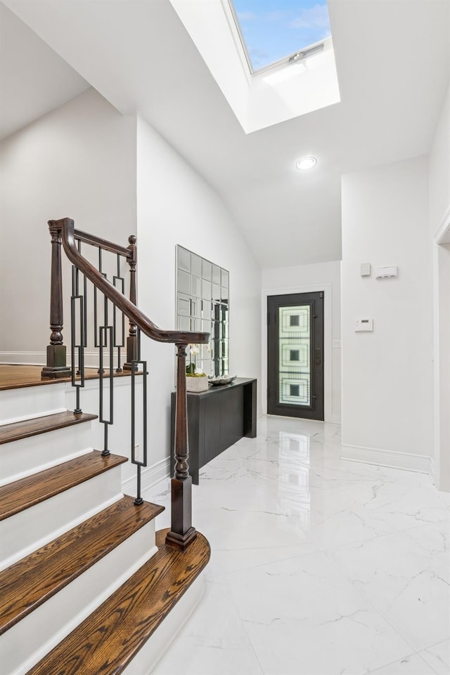 18 Woodcrest Rd, Kings Point, NY 11024 - foyer with marble finish flooring, a skylight, stairs, lofted ceiling, and recessed lighting