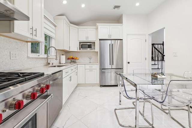 18 Woodcrest Rd, Kings Point, NY 11024 - kitchen with high end appliances, a sink, under cabinet range hood, light countertops, and white cabinetry