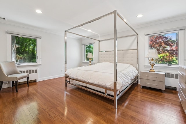 18 Woodcrest Rd, Kings Point, NY 11024 - bedroom featuring radiator, ornamental molding, multiple windows, dark wood-style floors, and recessed lighting