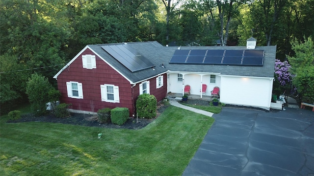 158 Parrott Rd, West Nyack, NY 10994 - view of front facade with a front yard, roof mounted solar panels, roof with shingles, and a chimney