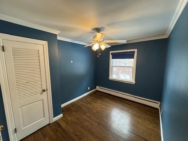 158 Parrott Rd, West Nyack, NY 10994 - empty room featuring a baseboard heating unit, a ceiling fan, dark wood-style floors, baseboards, and ornamental molding